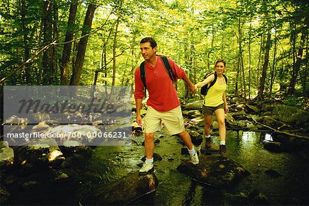 Hiking Couple Crossing Stream Belgrade Lakes, Maine, USA