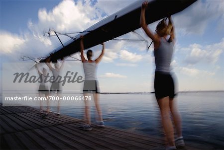 Female Rowers Carrying Boat on Dock, Toronto, Ontario, Canada