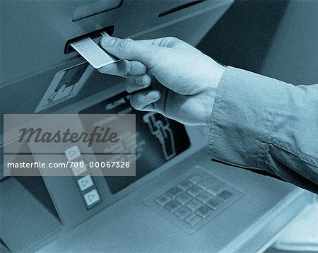 Hand Inserting Card into Bank Machine
