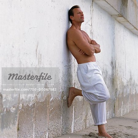 Man Leaning on Wall with Arms Crossed Outdoors - Stock Photo - Masterfile -  Rights-Managed, Artist: David P. Hall, Code: 700-00067882