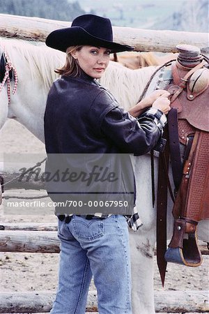 Portrait of Woman Adjusting Saddle