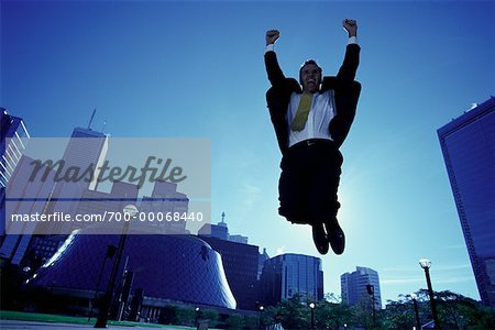 Ecstatic Businessman Jumping in Air, Toronto, Ontario, Canada