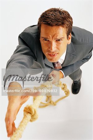 Overhead View of Businessman Climbing Rope