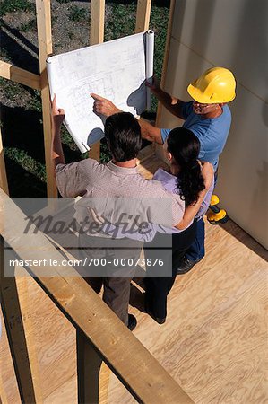 Contractor and Couple Looking at Blueprints Ontario, Canada