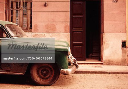 Parked Car near Building Entrance Havana, Cuba
