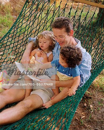 Father Reading to Children in Hammock