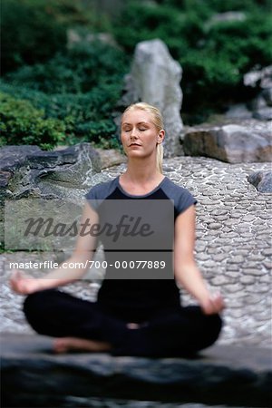 Woman Sitting in Lotus Position Outdoors