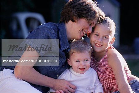 Mother, Daughter and Baby Sitting Outdoors