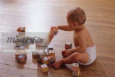 Baby Sitting on Floor, Playing With Blocks