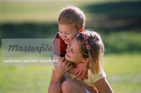Girl and Boy Embracing Outdoors
