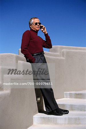 Mature Man Using Cell Phone on Steps