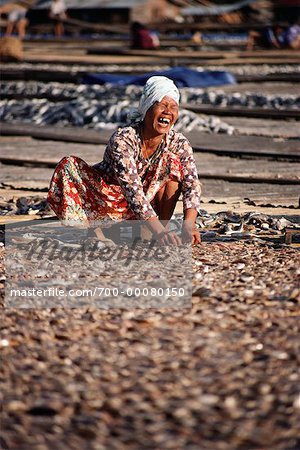Woman Laughing, Sorting Dried Fish, Pahang, Malaysia