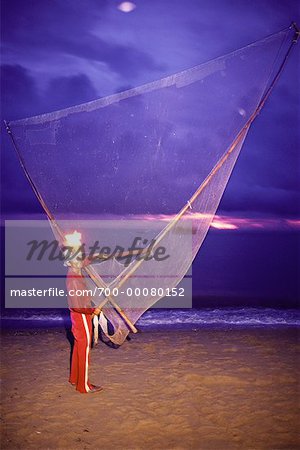 Portrait of Man with Fishing Net And Kerosene Head Lamp on Beach Pantai Kundor, Malaysia