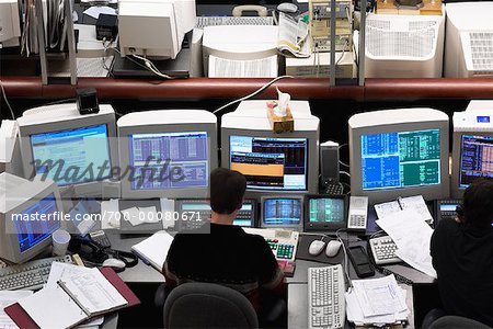 Back View of Person Using Computer in Stock Market Trading Room