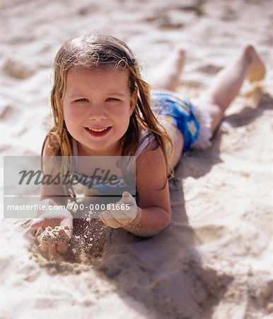 Portrait of Girl in Swimwear Lying in Surf on Beach