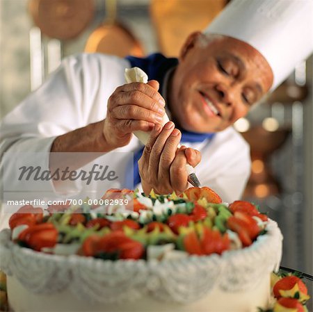 Premium Photo | Pastry chef decorates the cake with chocolate levels of  berries and mint.