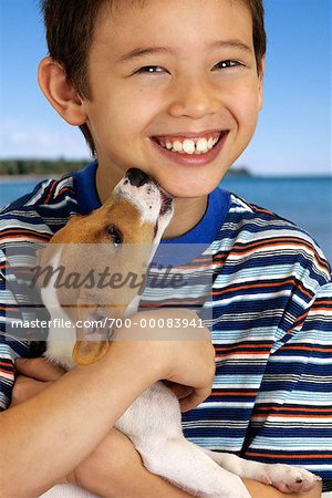 Portrait of Boy with Dog Licking Face