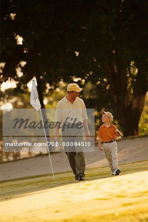 Father and Son Walking on Golf Course