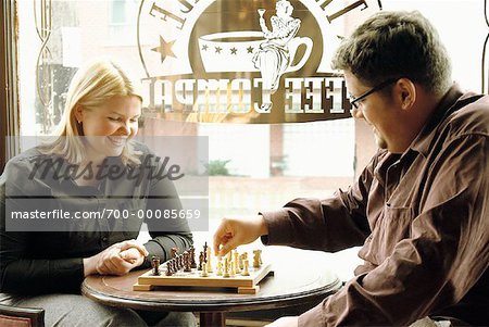 Couple Sitting in Cafe, Playing Chess