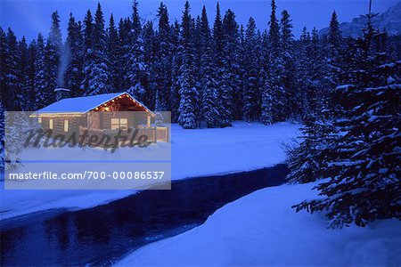 Log Cabin By Stream In Winter At Dusk Stock Photo Masterfile