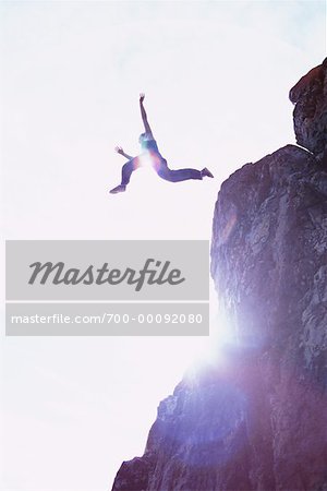 woman jumping off cliff