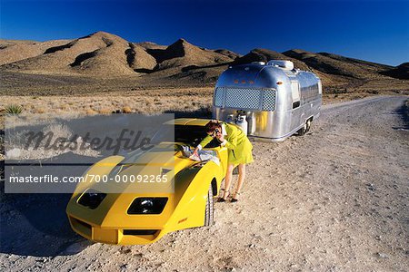 Woman With Sportscar and Trailer in the Desert