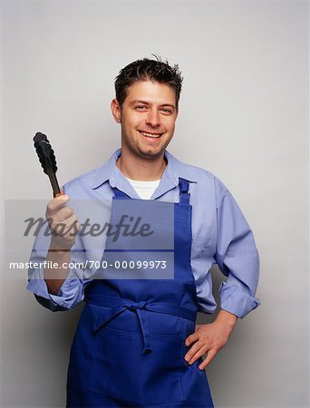 Cooking tongs holding bbq chicken hi-res stock photography and