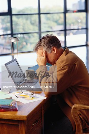 Frustrated Man Working on Laptop