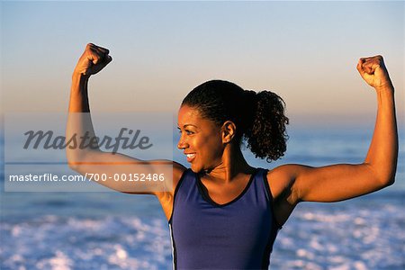 Woman Flexing Arms on the Beach