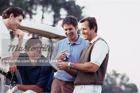 Men Looking at Golf Score Card