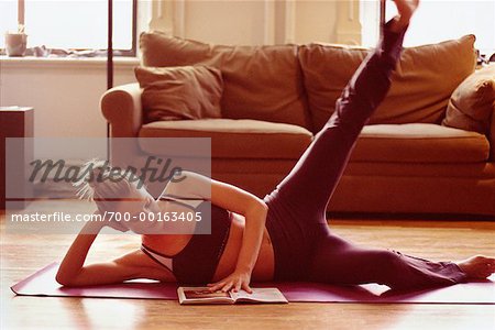 Woman Reading while Stretching