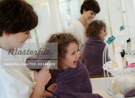 Mother Blow-Drying Daughter's Hair