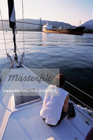 Man Sitting on Sailboat