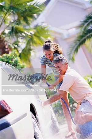 Father and Daughter Washing Car