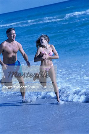 Father and Daughter Running On Beach