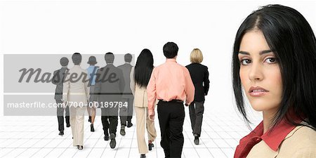 Portrait of Businesswoman with Business People Walking Away