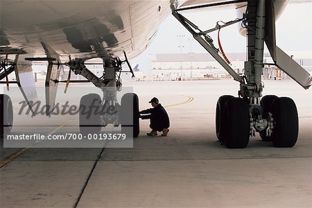 Aircraft Worker Checking Landing Gear