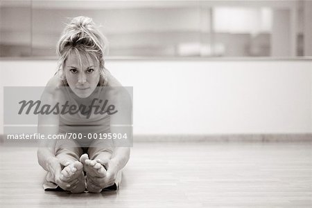 Woman Stretching in Gym