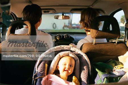 Couple with Baby in Vehicle - Stock Photo - Masterfile - Rights