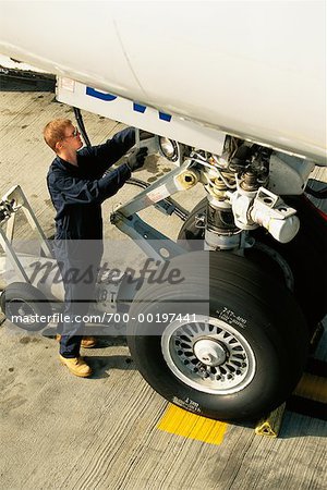 Airplane Mechanic Working on Landing Gear