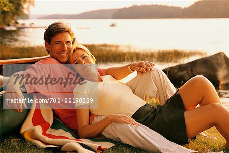 Couple Relaxing by Lake