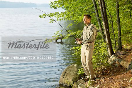 Man Fishing Long Pond, Belgrade Lakes Maine, USA - Stock Photo