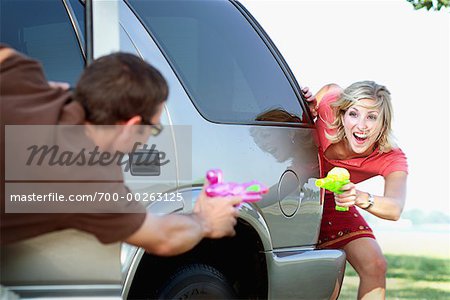 Couple Having Water Gun Fight