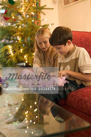 Girl and Boy Wrapping Christmas Gifts