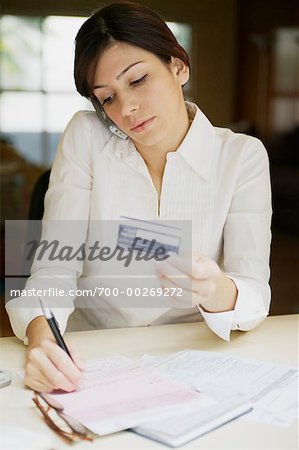 Woman on Phone Holding Credit Card