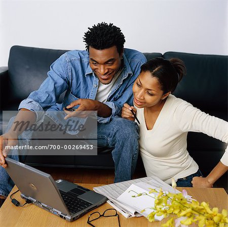 Couple Using Laptop to Check Their Personal Finances