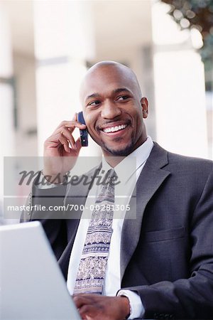 Businessman with Laptop and Cell Phone