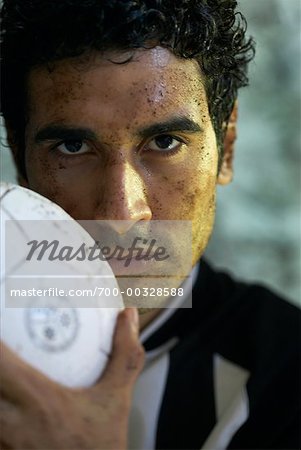 Man with Dirty Face and Soccer Ball