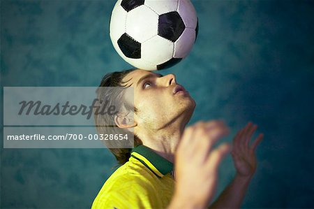 Balancing the Soccer Ball stock photo. Image of focused - 43310912