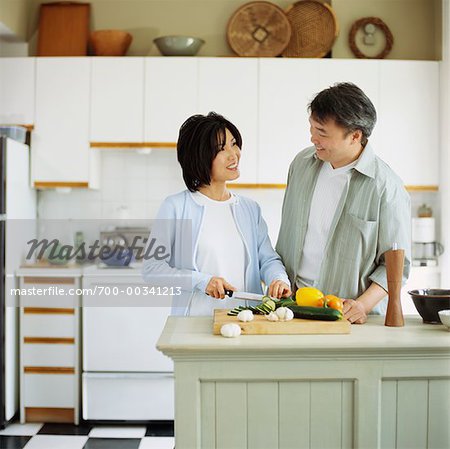 Couple Preparing Food in Kitchen